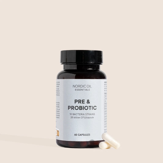 Nordic Oil Essentials Pre & Probiotic kosttilskud i mørk glasflaske med to hvide kapsler ved siden af