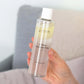 Nordic Cosmetics 2-Phase Cleansing Water med CBD og Jojoba-olie holdt i en hånd
