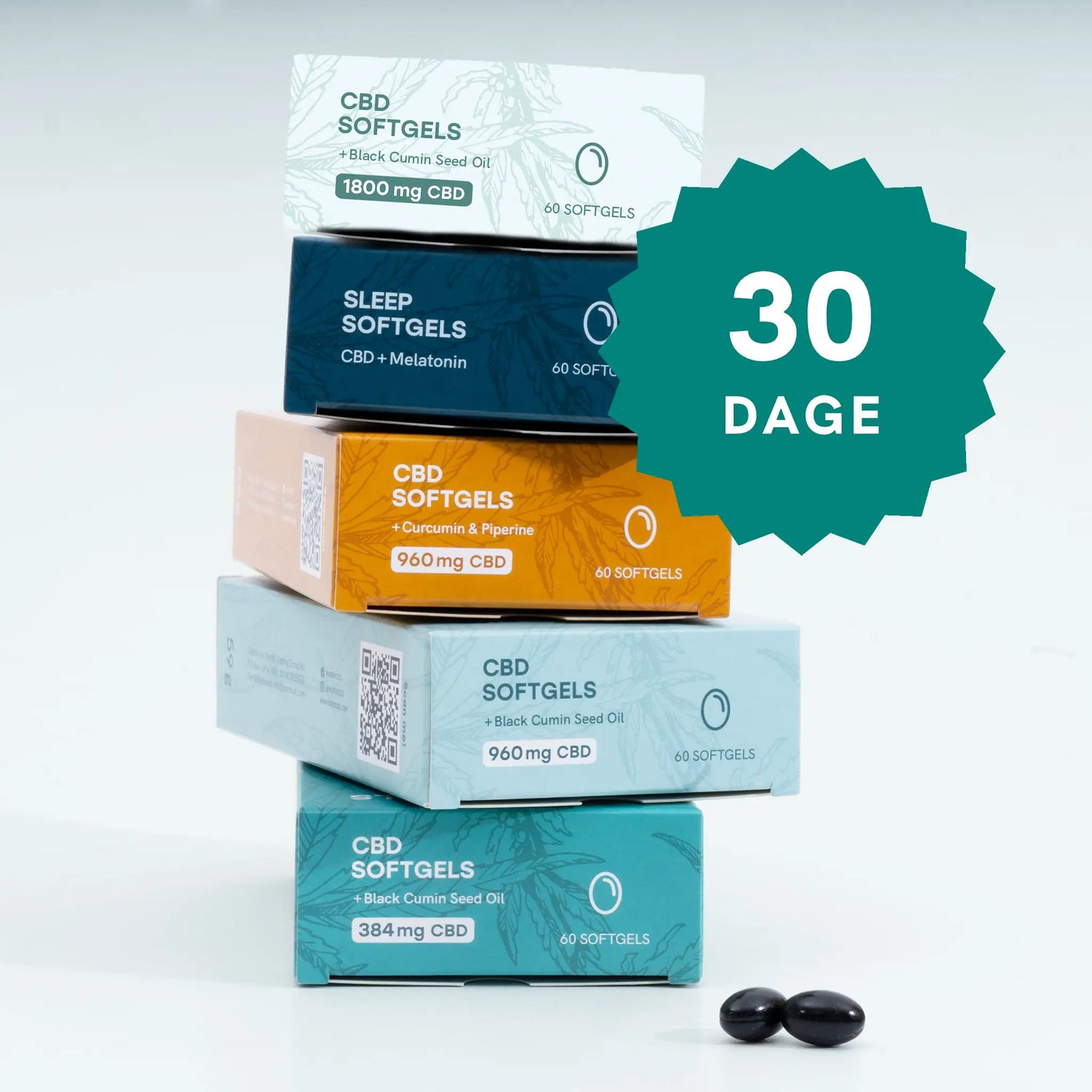 Stakke af farverige CBD-softgelbokse med et stort 30 DAGE-banner og to sorte softgels foran.