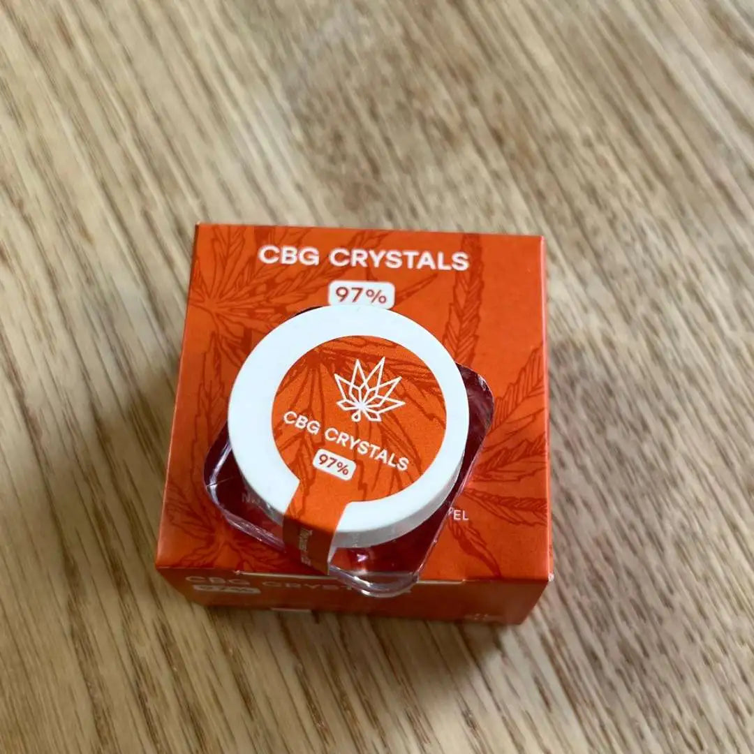 CBG crystals i orange emballage med hvid ring og cannabisblad-ikon (97%)