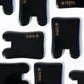 Sort glossy kosmetikemballage med gyldent Nordic Cosmetics-logo på hvid baggrund