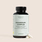 Nordic Oil Essentials Magnesium Complex-flaske med to kapsler ved siden af