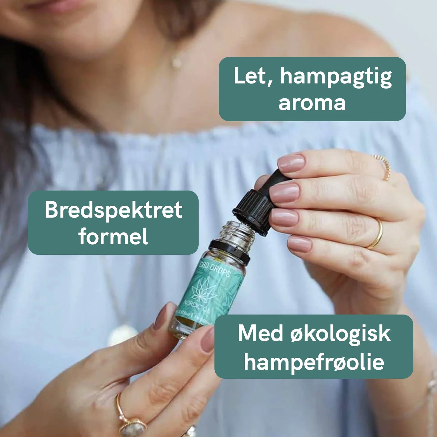 Person der holder en CBD-olie dropper med grøn etiket; tre grønne tekstbobler med dansk tekst på billedet.