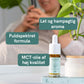 CBD-dråber i glasflaske fra Nordic Oil på et bord med en grøn plante i baggrunden