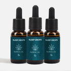 Tre brune glasflasker med pipette og blå etiketter mærket Sleep Drops fra Nordic Oil
